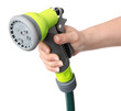 Woman holding watering hose with sprinkler on white background, closeup