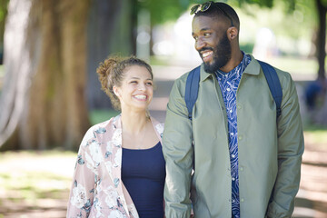 Canvas Print - Young couple holding hands, walking in park