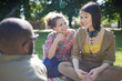 © KOTO - Young friends relaxing in sunny summer park