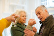 © KOTO - Sales assistant helping senior woman trying on jewelry in shop