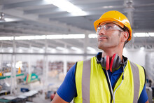 Portrait Serious Male Worker In Protective Eyewear And Hard-hat In Factory