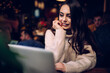 © BullRun - Joyful young lady typing on laptop in office