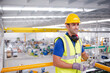 © KOTO - Portrait serious male worker in protective eyewear and hard-hat in factory