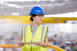 Portrait confident female supervisor with clipboard in steel factory