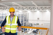 © KOTO - Serious male supervisor leaning on platform railing in factory