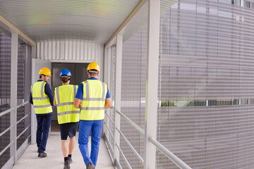 Wall Mural - Supervisors and worker with clipboard talking in factory