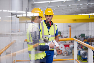 Wall Mural - Supervisor and worker talking in steel factory