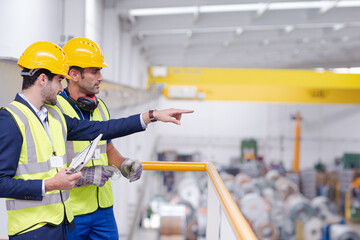 Wall Mural - Supervisor and worker talking in steel factory