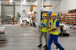 © KOTO - Supervisor and workers talking in warehouse