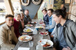 © KOTO - Portrait of smiling friends eating at restaurant outdoor patio