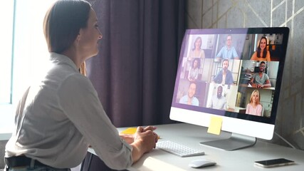 Wall Mural - Group of diverse multiracial people on the laptop screen, a young woman is waving and greeting, talking with colleagues, employees online. Video conference, brainstorm, webinar concept. 4k