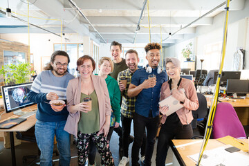 Team posing in office, smiling