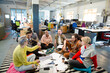 © KOTO - Team sitting on floor, discussing paperwork