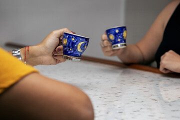 Wall Mural - Closeup shot of cups of coffee on hands