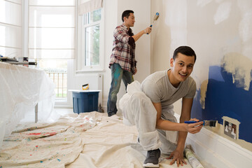 Portrait happy man painting wall