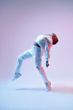 Active Black Dancer In Headset Jumping On Light Background