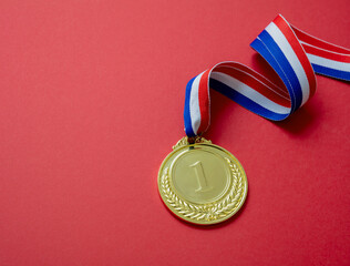 Wall Mural - Gold medal. Champion trophy award and ribbon. Prize in sport for winner isolated on red background