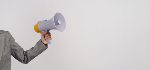 Wall Mural - Hand is hold megaphone and wear grey suit on white background..