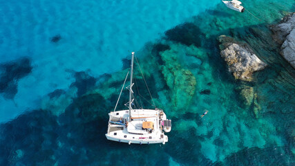 Wall Mural - Aerial drone photo of beautiful catamaran sailing yacht anchored in tropical exotic turquoise sea exotic bay
