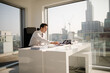 © KOTO - Businessman working at desk in modern office