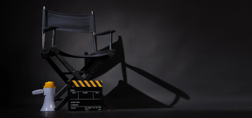 Black director chair and Clapper board or movie Clapperboard with megaphone on black background.use in video production or film cinema industry