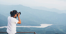 An Asian Man Photographer Is Photographing A Mountain At Doi Pha Tang, A Popular Tourist Attraction In Thailand, Beautiful Nature To Travel On Vacation Concept.