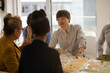 © KOTO - Business people eating sushi lunch in conference room