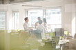 © KOTO - Business people talking in open plan office
