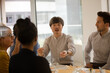 © KOTO - Business people eating sushi lunch in conference room