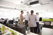 © KOTO - Business people talking in open plan office