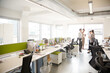 © KOTO - Business people talking in open plan office
