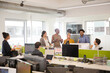 © KOTO - Business people talking in open plan office