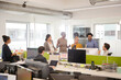 © KOTO - Business people talking in open plan office