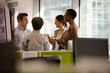 © KOTO - Business people talking in open plan office