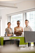 © KOTO - Smiling business people posing in open plan office