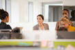 © KOTO - Businesswomen talking in open plan office