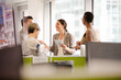 © KOTO - Business people talking in open plan office