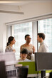 © KOTO - Business people talking in open plan office