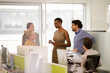 © KOTO - Business people talking in open plan office