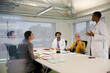 © KOTO - Businesswoman leading conference room meeting