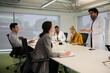© KOTO - Businessman leading conference room meeting