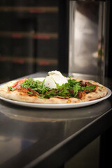 Sticker - Vertical shot of a freshly baked pizza with prosciutto, arugula, and mozzarella