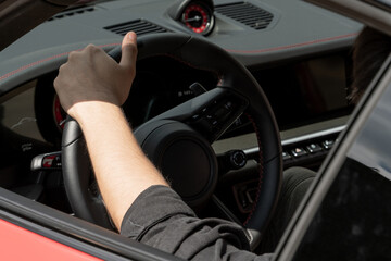 Poster - Person's hand on a steering wheel