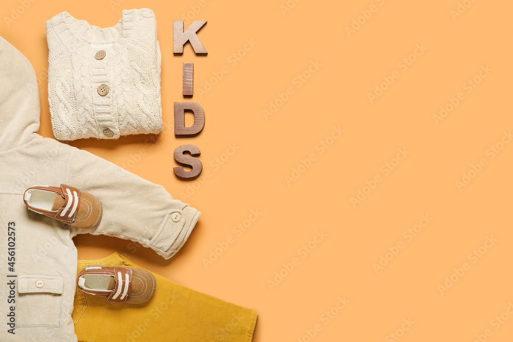 Stylish baby clothes on color background