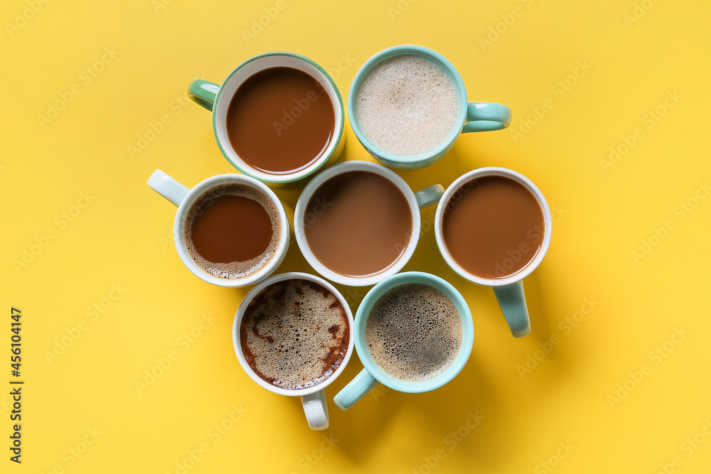 Cups of tasty coffee on color background