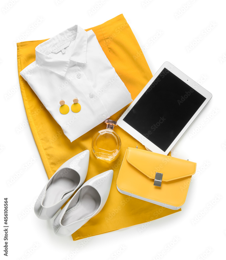 Female clothes, stylish accessories and tablet computer on white background