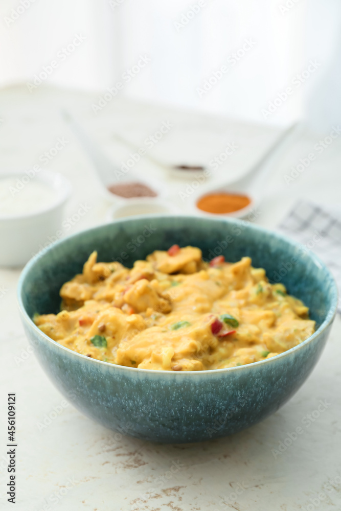 Bowl of tasty chicken curry on table