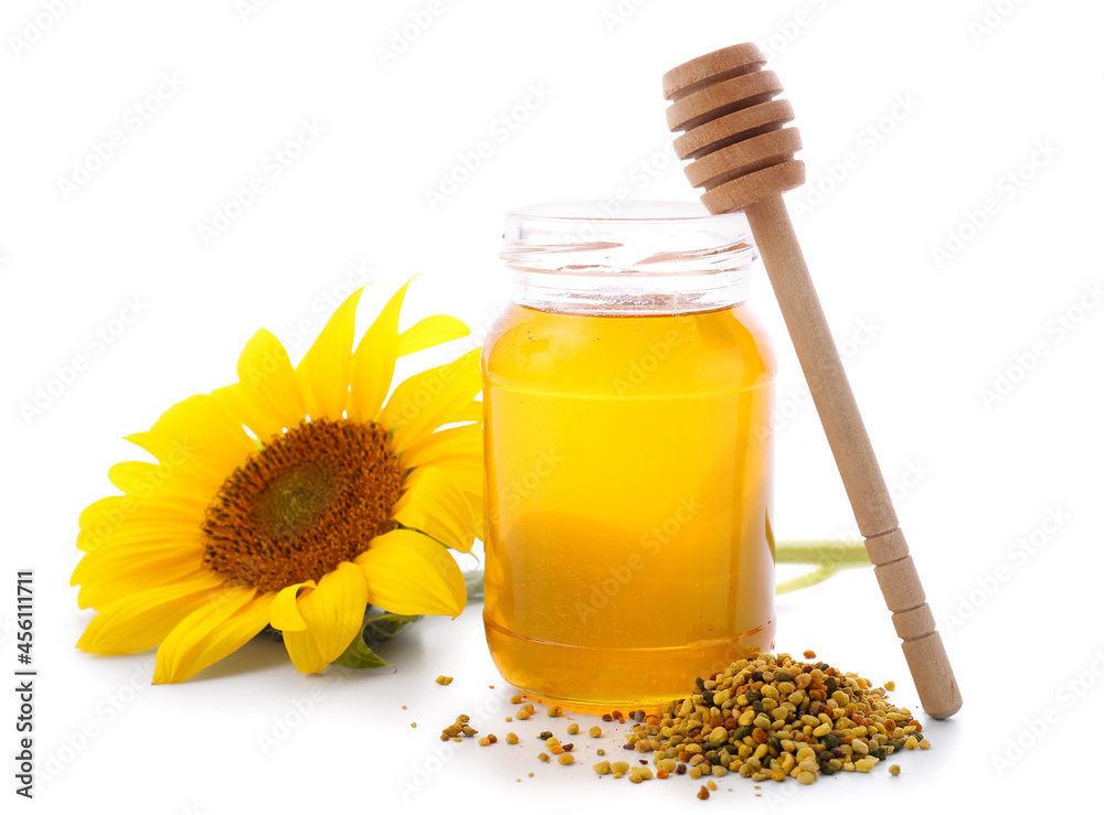 Jar of honey with bee pollen on white background
