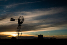 Sunset With Windmill And Water Tank In The Outback