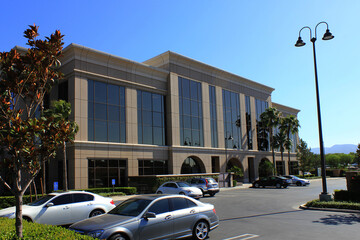 Front of a modern office building from parking lot